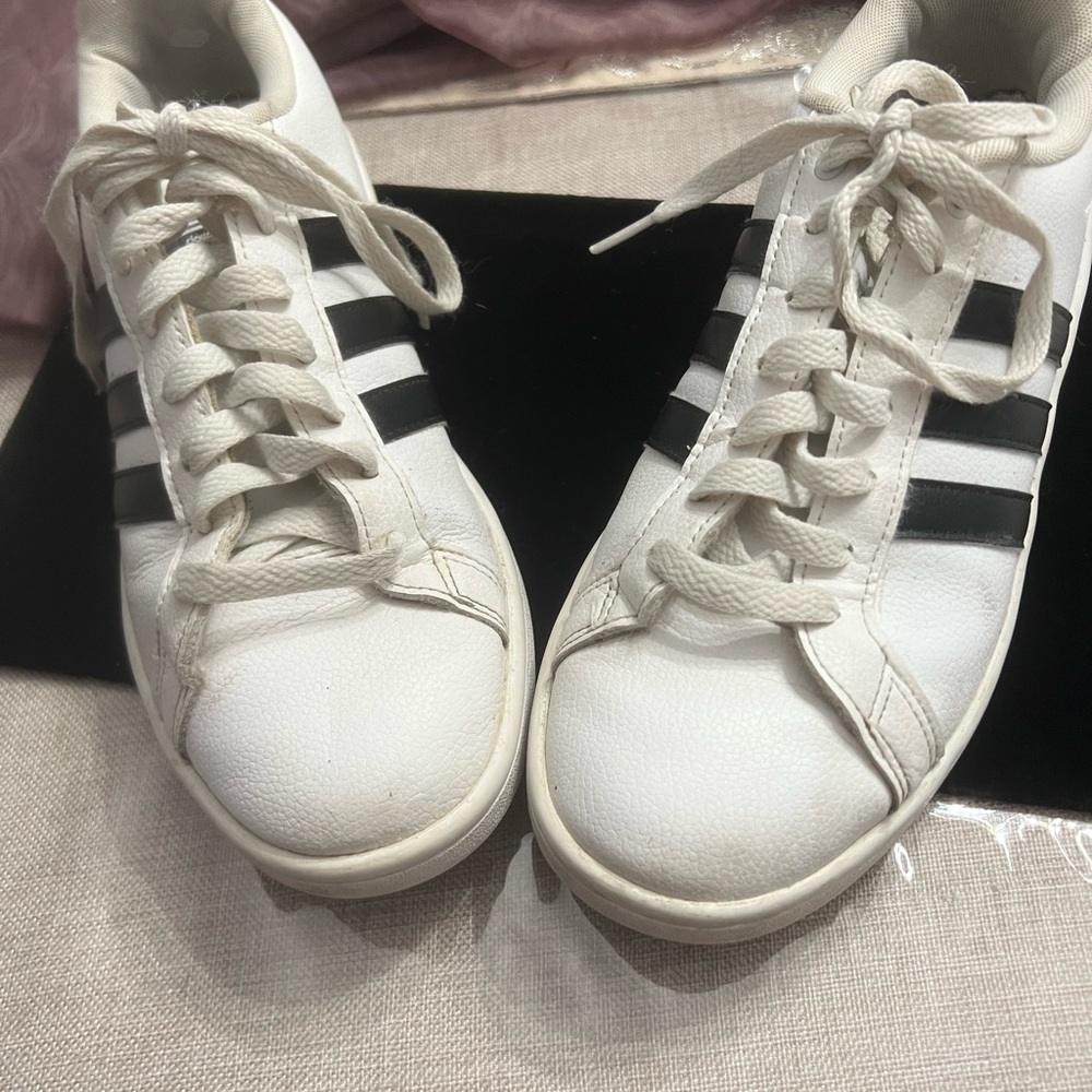 White Adidas sneakers with black stripes down side